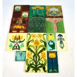 A group of twelve various Art Nouveau stylised floral decorated tiles,