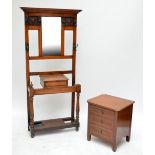 An early 20th century oak hall stand with carved mask detail and a chest of three drawers (2).