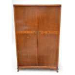 A 1940s oak and walnut crossbanded two door wardrobe.