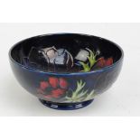 MOORCROFT; a modern "Anemone" pattern tube lined decorated bowl on dark blue ground,