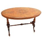 A Victorian walnut oval loo table with inlaid detail,