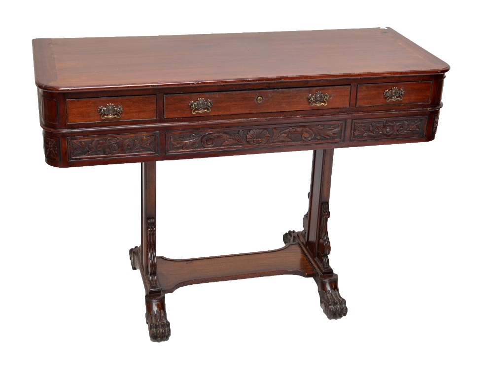 An unusual three drawer side table with carved detail and central vertical supports to paw feet,