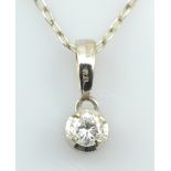 An 18ct white gold and diamond pendant, the single round cut stone approx 0.