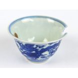 A Chinese porcelain bowl painted in underglaze blue with two dragons chasing the pearl of wisdom