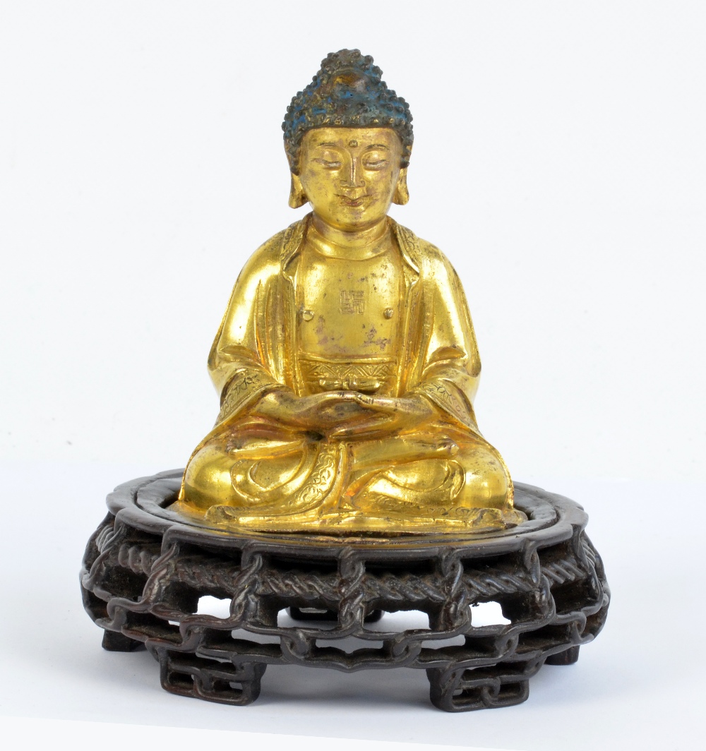 A Chinese late Ming period gilt bronze figure of seated Buddha Amitabha,