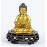 A Chinese late Ming period gilt bronze figure of seated Buddha Amitabha,