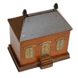An early 20th century wood and copper mounted cigarette dispenser modelled as a house, width 13.5cm.