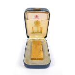 A boxed gold plated textured Dunhill Rollagas lighter, RE24163, with manual.