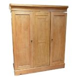 A large pine three door wardrobe,