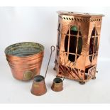 An Arts and Crafts copper stove converted into a lamp with red tinted glass panels,