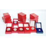 A collection of Halcyon Days enamel circular Christmas boxes from 1986 to 2000,