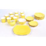 SHELLEY; a yellow 'Dainty' pattern tea set comprising ten trios, a cream jug,