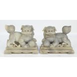 An opposing pair of Chinese carved soapstone Dogs of Fo,