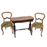 An Edwardian walnut folding card table with turned and carved supports,