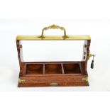 An Edwardian oak and brass mounted tantalus three section frame,