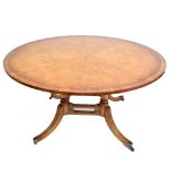 A reproduction burr elm radially veneered and crossbanded circular centre table,