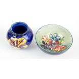 MOORCROFT; a 'Spring Flowers' pattern tube line decorated circular bowl on light turquoise ground,