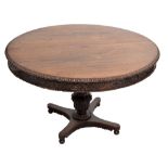 An unusual Anglo-Indian padouk centre table with carved rim and frieze,