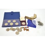 A small quantity of British coins comprising modern crowns, pre-1947 florins and shillings,