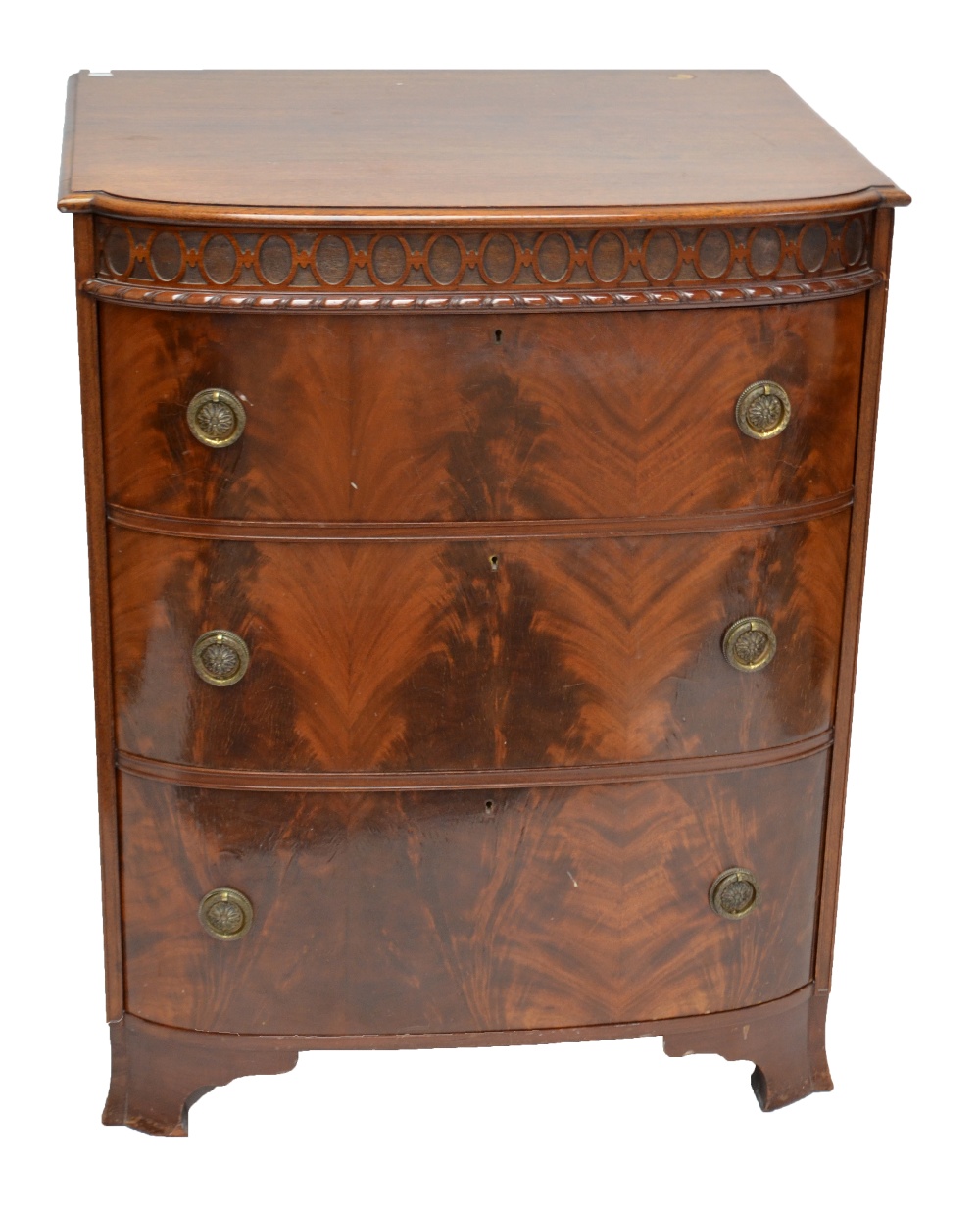 A mahogany bowfronted three drawer chest, formerly the centre section from a compactum wardrobe,