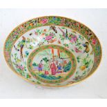 A 19th century Chinese Canton Famille Rose bowl centred with a group of figures and a horse in