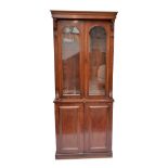 A Victorian mahogany bookcase on cupboard (af), width 101cm.