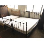 A pair of London Wrought Iron Bed Company single beds, complete with side rails.