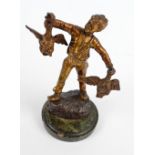 An early 20th century gilt bronze figure of a Dutch peasant boy holding two geese, height 17.
