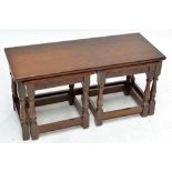 A Priory style nest of three oak occasional tables.