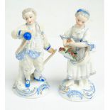 A pair of late 19th century German porcelain courting figures of a man with hoe and a woman holding