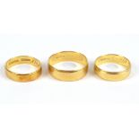 Three 18ct yellow gold wedding bands, two with inscription to the inside, largest size S,