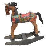 A carved and painted rocking horse complete with caparison, removable tail on simple rocker,