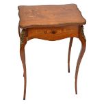 A French rosewood and satinwood inlaid serpentine outlined single drawer side table raised on