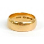 An 18ct yellow gold broad wedding band, size O, approx 9.2g.