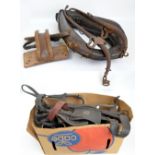 A quantity of heavy horse tack including collar, leather straps, brass mounted straps,