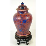 A large Chinese Kangxi clobbered baluster jar and cover painted with blue flowers and leaves on a