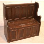 A stained pine hall bench with hinged storage seat, width 92cm.