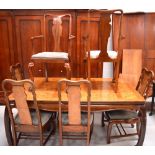 A 20th century Oriental-style walnut extending dining table with two inserts,