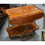 A retro Italian floral-inlaid drinks trolley on ornamental brass-effect wheels, width approx 70cm.