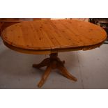 A 20th century pine extending kitchen table, width when extended approx 150cm.