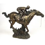 A bronzed resin sculpture of a racehorse and jockey, height 53cm.