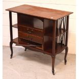 An Edwardian mahogany music cabinet, three central drawers with small shelves to either sides,