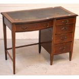 A c1930s mahogany kneehole writing desk, one bow-front central drawer,