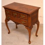 A reproduction mahogany lowboy, two long drawers with brass handles and escutcheons,