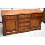 A reproduction yew and elm sideboard,