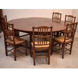 A c1900 oak oval drop-leaf dining table on turned and baluster supports and turned cross-stretchers