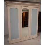 A Victorian blue and white painted three-section wardrobe with central mirror and cupboard door to
