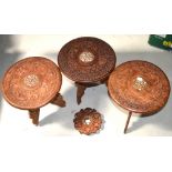 Three Eastern carved side tables inlaid with bone and a similar trivet (4).