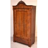 A Victorian mahogany single-door wardrobe with curved carved frieze,