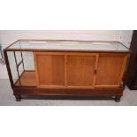 An early 20th century oak-framed haberdashery counter with glazed display panels,